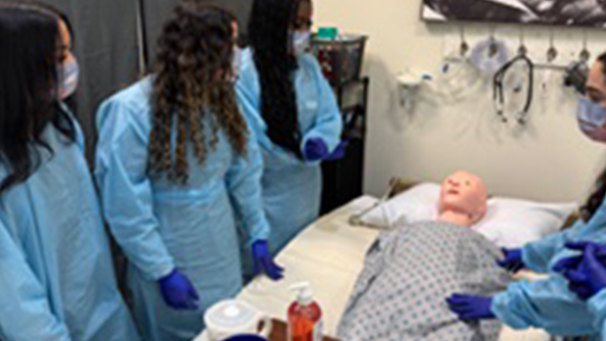 Phlebotomy training students practicing clinical skills on a mannequin in Tracy, CA